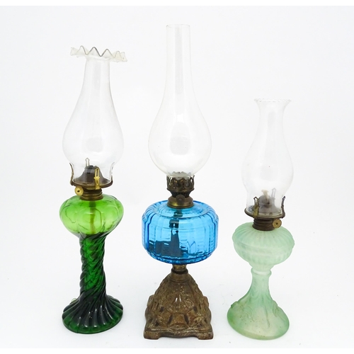 1424 - Three early 20thC oil lamps to include a French Art Nouveau example by Portieux Vallerysthal with fi... 