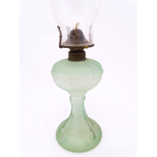 1424 - Three early 20thC oil lamps to include a French Art Nouveau example by Portieux Vallerysthal with fi... 