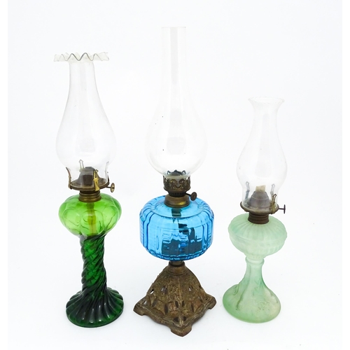 1424 - Three early 20thC oil lamps to include a French Art Nouveau example by Portieux Vallerysthal with fi... 