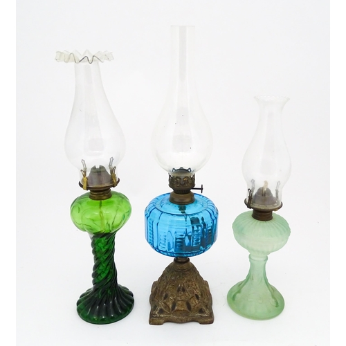 1424 - Three early 20thC oil lamps to include a French Art Nouveau example by Portieux Vallerysthal with fi... 