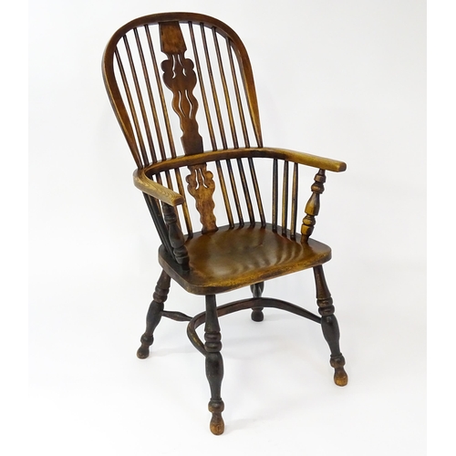 1500 - A mid 19thC ash and elm Windsor chair with a double bowed backrest and a pierced back splat above a ... 