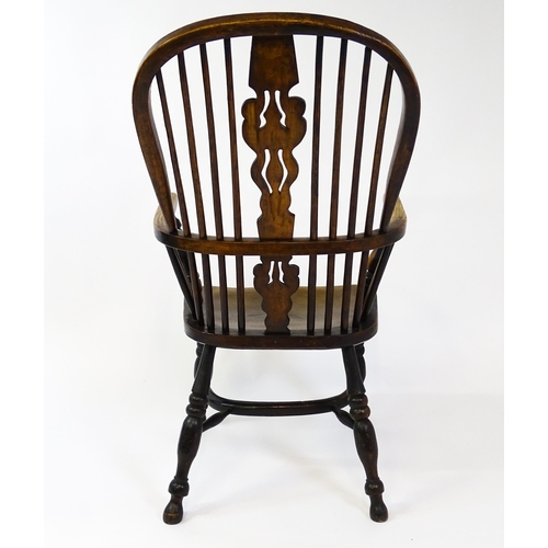 1500 - A mid 19thC ash and elm Windsor chair with a double bowed backrest and a pierced back splat above a ... 