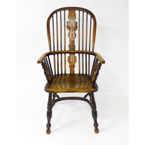 1500 - A mid 19thC ash and elm Windsor chair with a double bowed backrest and a pierced back splat above a ... 