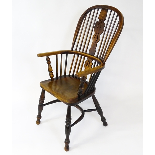 1500 - A mid 19thC ash and elm Windsor chair with a double bowed backrest and a pierced back splat above a ... 