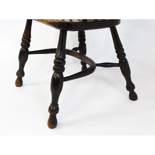 1500 - A mid 19thC ash and elm Windsor chair with a double bowed backrest and a pierced back splat above a ... 