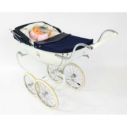 955A - Toys: A 20thC Silver Cross dolls pram with cream exterior. Together with a plastic doll with blinkin... 