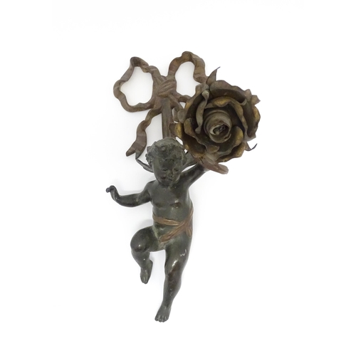 1421 - A cast bronze wall light sconce modelled as a cherub holding aloft a scrolling flower. Approx. 12