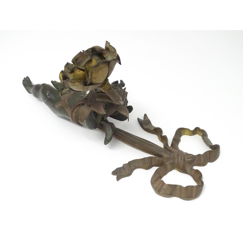 1421 - A cast bronze wall light sconce modelled as a cherub holding aloft a scrolling flower. Approx. 12