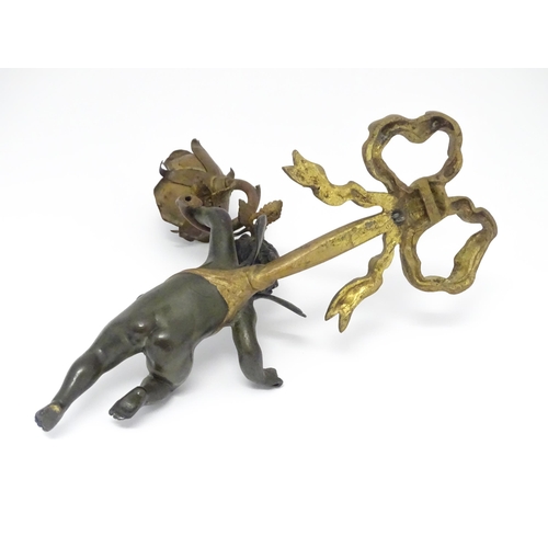 1421 - A cast bronze wall light sconce modelled as a cherub holding aloft a scrolling flower. Approx. 12