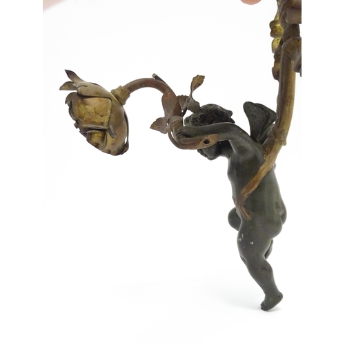 1421 - A cast bronze wall light sconce modelled as a cherub holding aloft a scrolling flower. Approx. 12