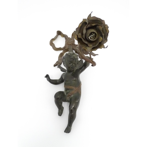 1421 - A cast bronze wall light sconce modelled as a cherub holding aloft a scrolling flower. Approx. 12