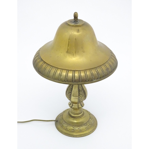 1422 - A 20thC brass table lamp with foliate detail and brass domed shade. Approx. 17