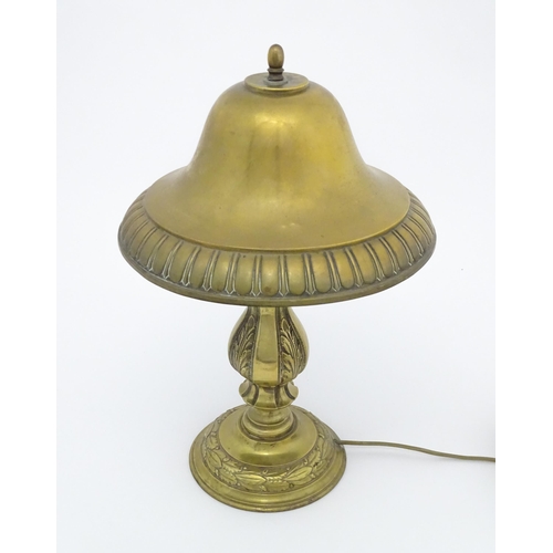 1422 - A 20thC brass table lamp with foliate detail and brass domed shade. Approx. 17