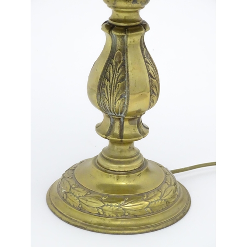 1422 - A 20thC brass table lamp with foliate detail and brass domed shade. Approx. 17