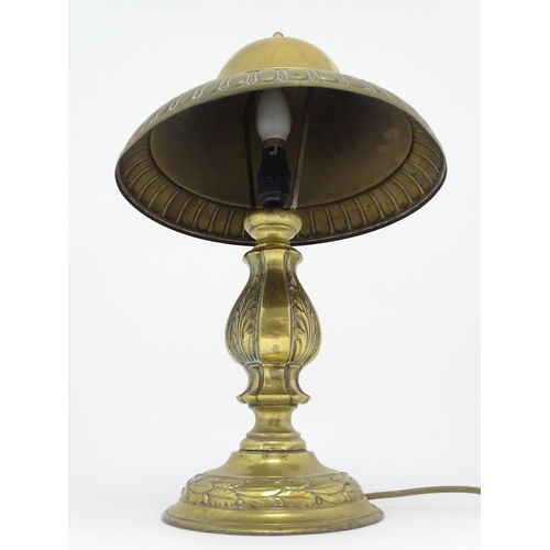 1422 - A 20thC brass table lamp with foliate detail and brass domed shade. Approx. 17