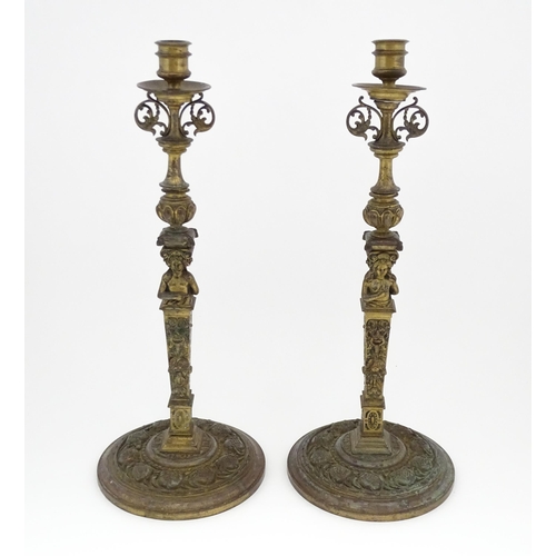 1423 - A pair of 19thC Continental cast brass tall candlesticks with figural, lions mask and foliate detail... 