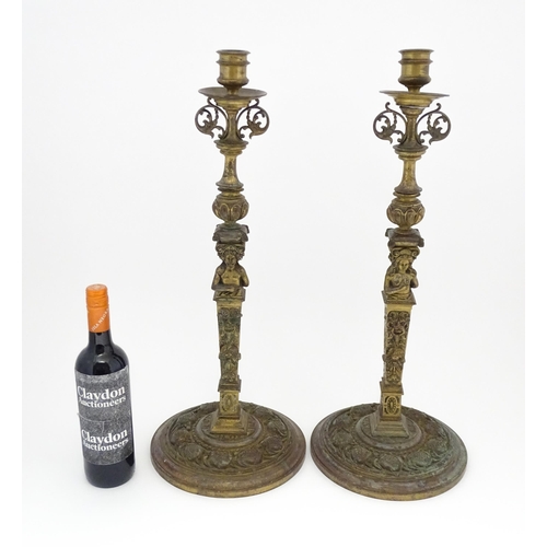 1423 - A pair of 19thC Continental cast brass tall candlesticks with figural, lions mask and foliate detail... 