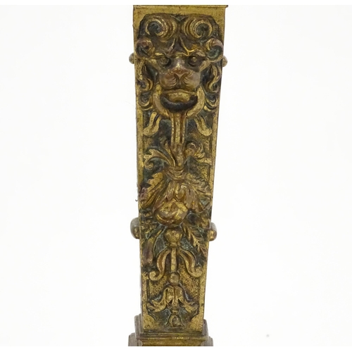 1423 - A pair of 19thC Continental cast brass tall candlesticks with figural, lions mask and foliate detail... 