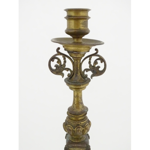 1423 - A pair of 19thC Continental cast brass tall candlesticks with figural, lions mask and foliate detail... 