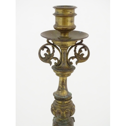 1423 - A pair of 19thC Continental cast brass tall candlesticks with figural, lions mask and foliate detail... 