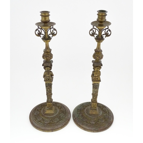 1423 - A pair of 19thC Continental cast brass tall candlesticks with figural, lions mask and foliate detail... 