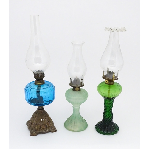 1424 - Three early 20thC oil lamps to include a French Art Nouveau example by Portieux Vallerysthal with fi... 