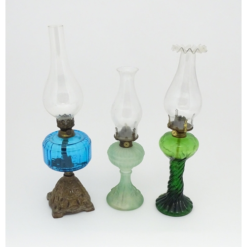 1424 - Three early 20thC oil lamps to include a French Art Nouveau example by Portieux Vallerysthal with fi... 