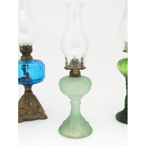 1424 - Three early 20thC oil lamps to include a French Art Nouveau example by Portieux Vallerysthal with fi... 