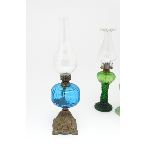 1424 - Three early 20thC oil lamps to include a French Art Nouveau example by Portieux Vallerysthal with fi... 