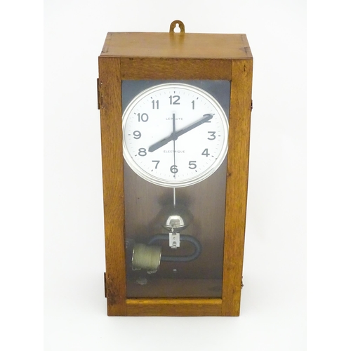 1445 - Lepaute : An early 20thC oak cased electric clock. The white dial with Arabic numerals signed Lepaut... 