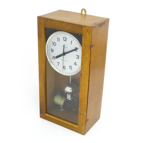 1445 - Lepaute : An early 20thC oak cased electric clock. The white dial with Arabic numerals signed Lepaut... 