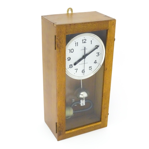 1445 - Lepaute : An early 20thC oak cased electric clock. The white dial with Arabic numerals signed Lepaut... 