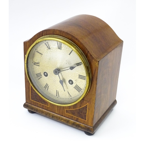 1446 - An early 20thC German walnut cased mantle clock with burr walnut veneered detail and satinwood strin... 