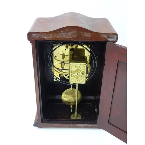 1447 - A mahogany cased mantle clock with silvered dial and Roman numerals. The by Gustav Becker 8-day move... 