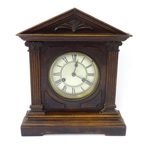 1450 - A late 19th/ early 20thC mahogany cased mantle clock by Philipp Haas & Sohne. The white enamel dial ... 