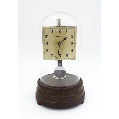 1452 - A Tempex electric clock mounted on a Bakelite base with chrome fitting. The squared dial with Arabic... 