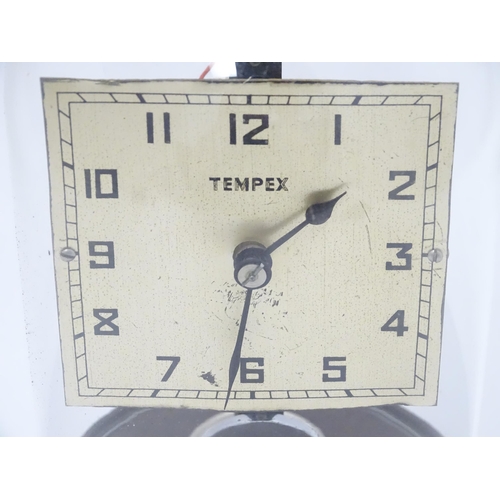 1452 - A Tempex electric clock mounted on a Bakelite base with chrome fitting. The squared dial with Arabic... 