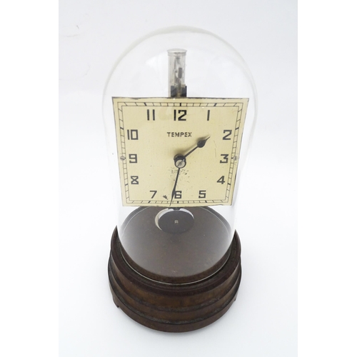 1452 - A Tempex electric clock mounted on a Bakelite base with chrome fitting. The squared dial with Arabic... 