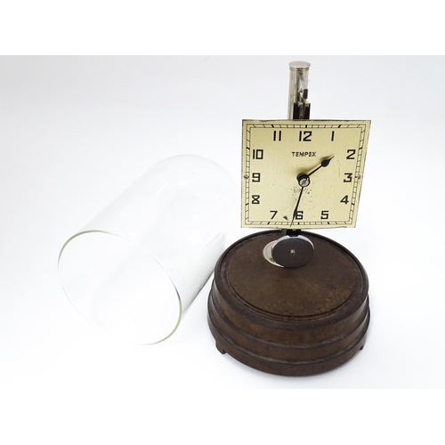 1452 - A Tempex electric clock mounted on a Bakelite base with chrome fitting. The squared dial with Arabic... 