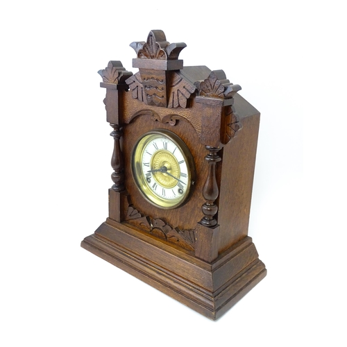 1453 - A Late 19thC / Early 20thC American oak cased mantle clock by the Ansonia Clock Company - New York, ... 