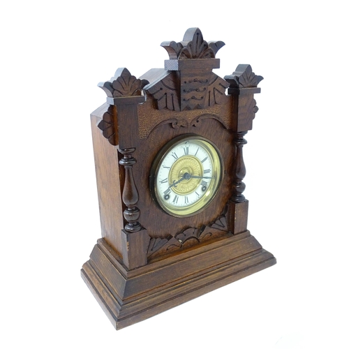 1453 - A Late 19thC / Early 20thC American oak cased mantle clock by the Ansonia Clock Company - New York, ... 