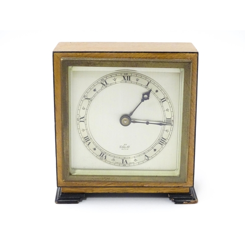 1467 - A 20thC mantle clock by Elliott. the dial with Roman numeral chapter ring and signed ' An Elliott Cl... 