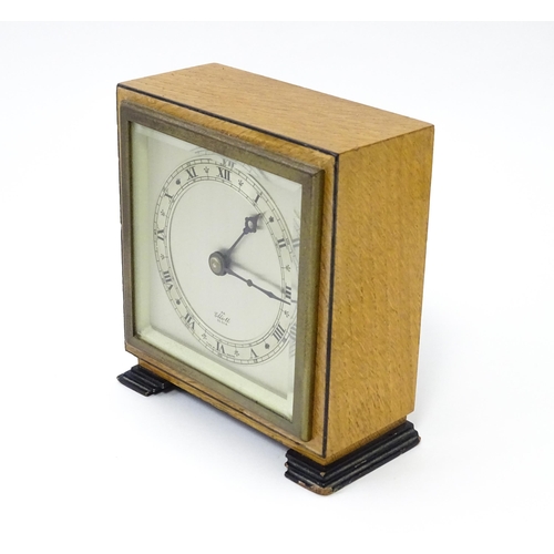 1467 - A 20thC mantle clock by Elliott. the dial with Roman numeral chapter ring and signed ' An Elliott Cl... 