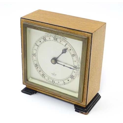 1467 - A 20thC mantle clock by Elliott. the dial with Roman numeral chapter ring and signed ' An Elliott Cl... 