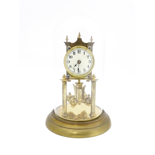 1468 - A 20thC anniversary / table clock with white enamel dial and Roman numerals. Under glass  dome Appro... 