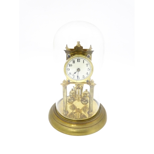 1468 - A 20thC anniversary / table clock with white enamel dial and Roman numerals. Under glass  dome Appro... 