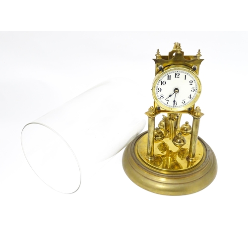 1468 - A 20thC anniversary / table clock with white enamel dial and Roman numerals. Under glass  dome Appro... 