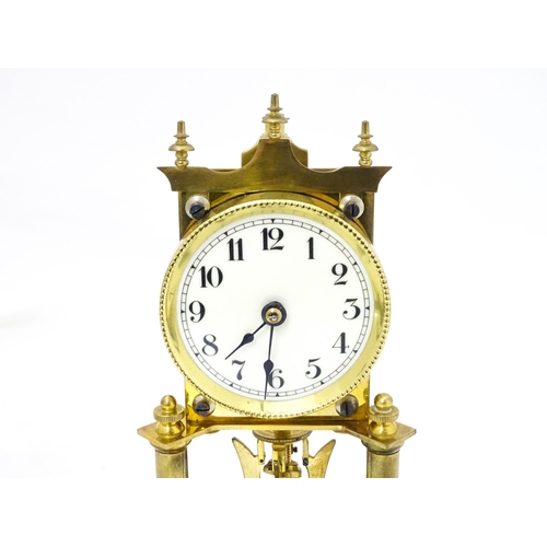 1468 - A 20thC anniversary / table clock with white enamel dial and Roman numerals. Under glass  dome Appro... 