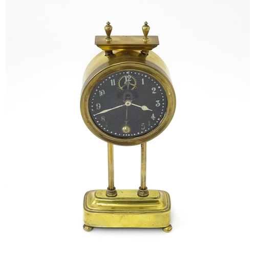 1469 - A brass cased Gravity clock  with dial with Arabic numerals and having exposed escapement. Marked to... 