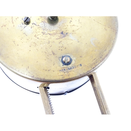 1469 - A brass cased Gravity clock  with dial with Arabic numerals and having exposed escapement. Marked to... 